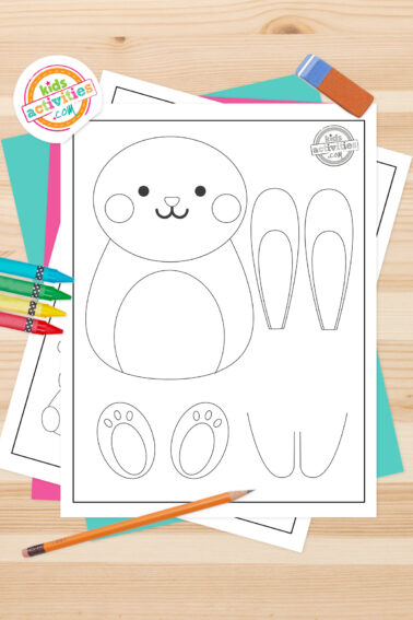 Black and white printed bunny template printables, lying on top of a blue-green sheet with multicolored letters on a light brown background. printed pdf version from Kids activities blog.