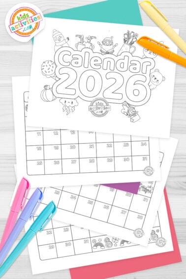 Black and white set of printable calendar 2026 for kids on top of blue-green and purple sheets with assorted crayons on a dark grey background. printed pdf version from Kids activities blog.