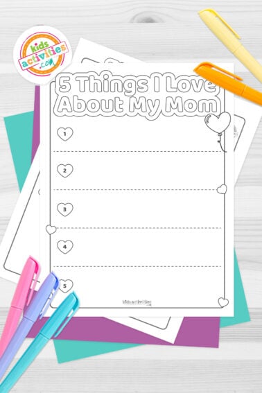 Set of black and white sheets “5 Things I love about my mom” printables, on top of blue-green and purple sheets with assorted crayons on a dark grey background. printed pdf version from Kids activities blog.
