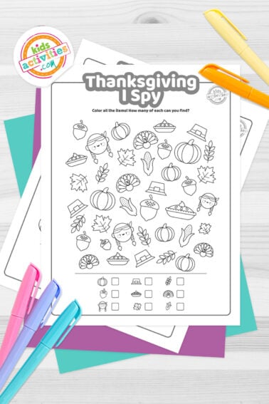 Black and white Thanksgiving I spy worksheet printables on top of blue-green and purple sheets with assorted markers on a dark grey background. printed pdf version from Kids activities blog.