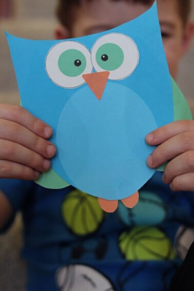 preschool owl craft with printable template finished and held by child