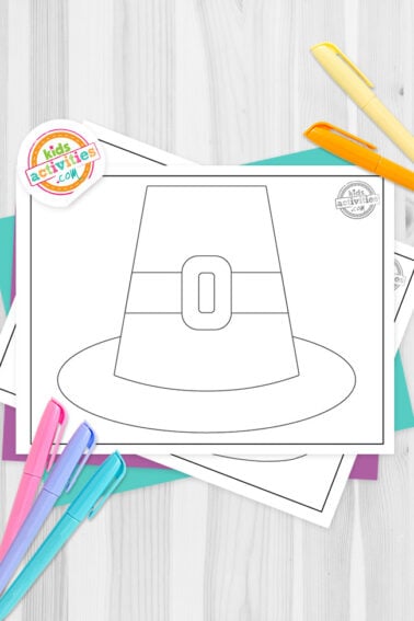 Black and white pilgrim hat template printables on top of blue-green and purple sheets with assorted markers on a dark grey background. printed pdf version from Kids activities blog.