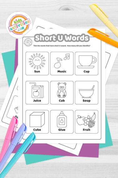 Black and white printed short U words worksheets on top of blue-green and purple sheets with assorted markers on a dark grey background. printed pdf version from Kids activities blog.