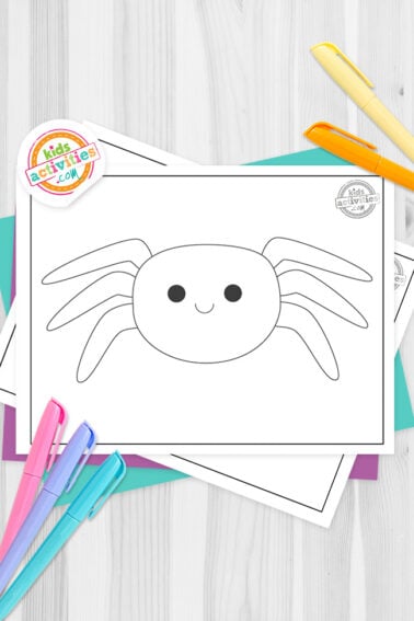 Black and white spider template printable on top of blue-green and purple sheets with assorted markers on a dark grey background. printed pdf version from Kids activities blog.