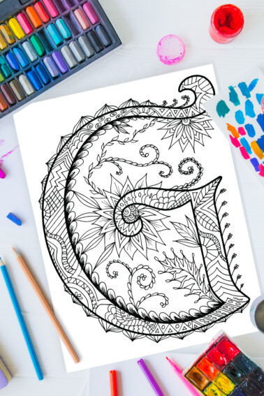 Zentangle alphabet coloring pages - letter g zentangle design on background of paint, colored pencils and art supplies