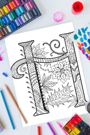 Zentangle alphabet coloring pages - letter h zentangle design on background of paint, colored pencils and art supplies
