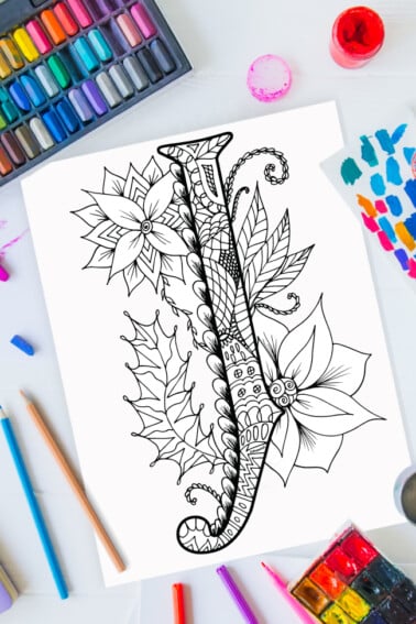 Zentangle alphabet coloring pages - letter j zentangle design on background of paint, colored pencils and art supplies