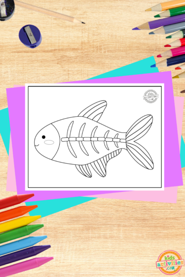X-ray tetra coloring page printed pdf file on a wood background with coloring supplies and colorful accessories- kids activities blog