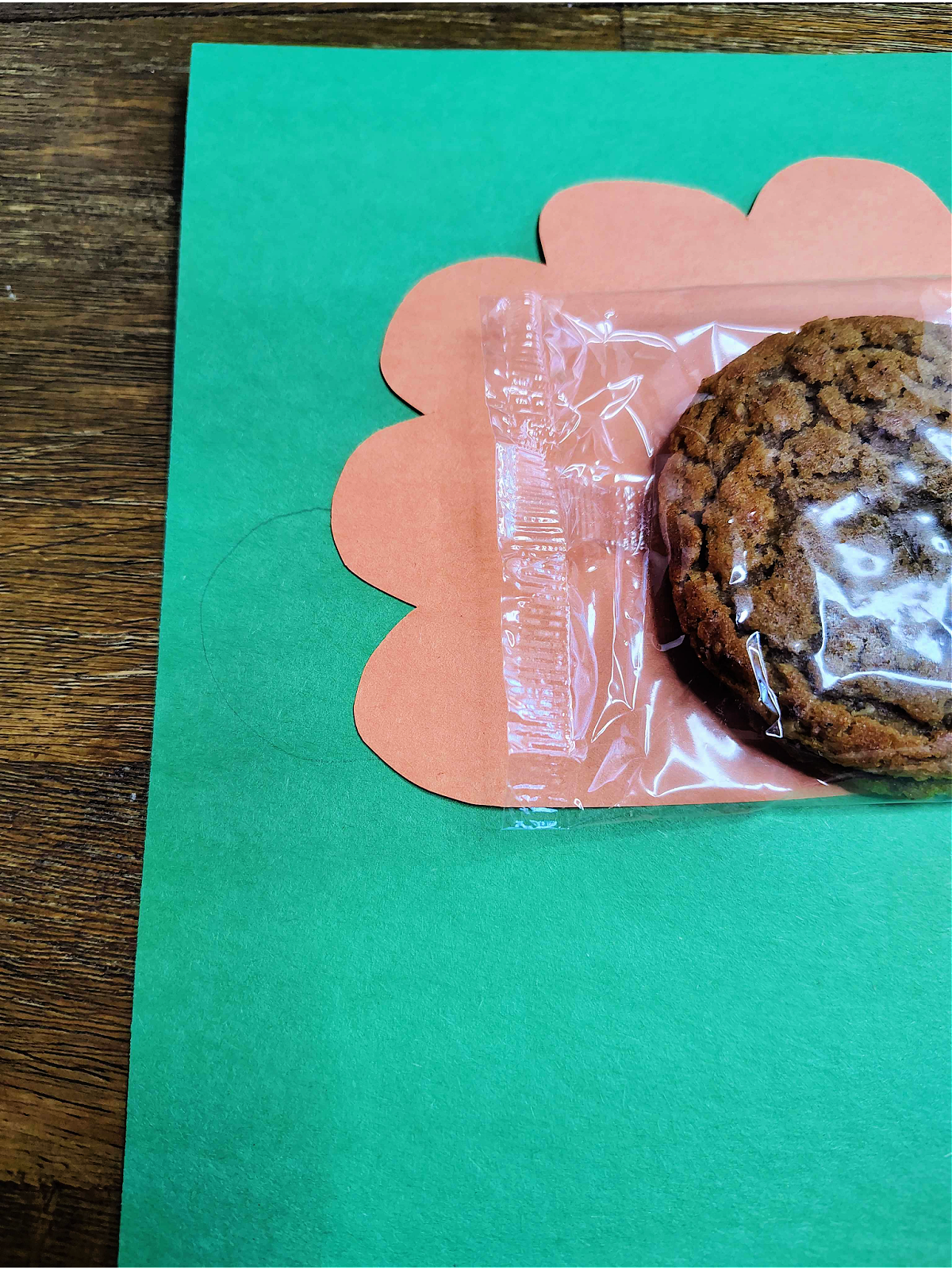 Turkey Craft- Step 3- Cookie and feathers on green paper- Kids Activities Blog